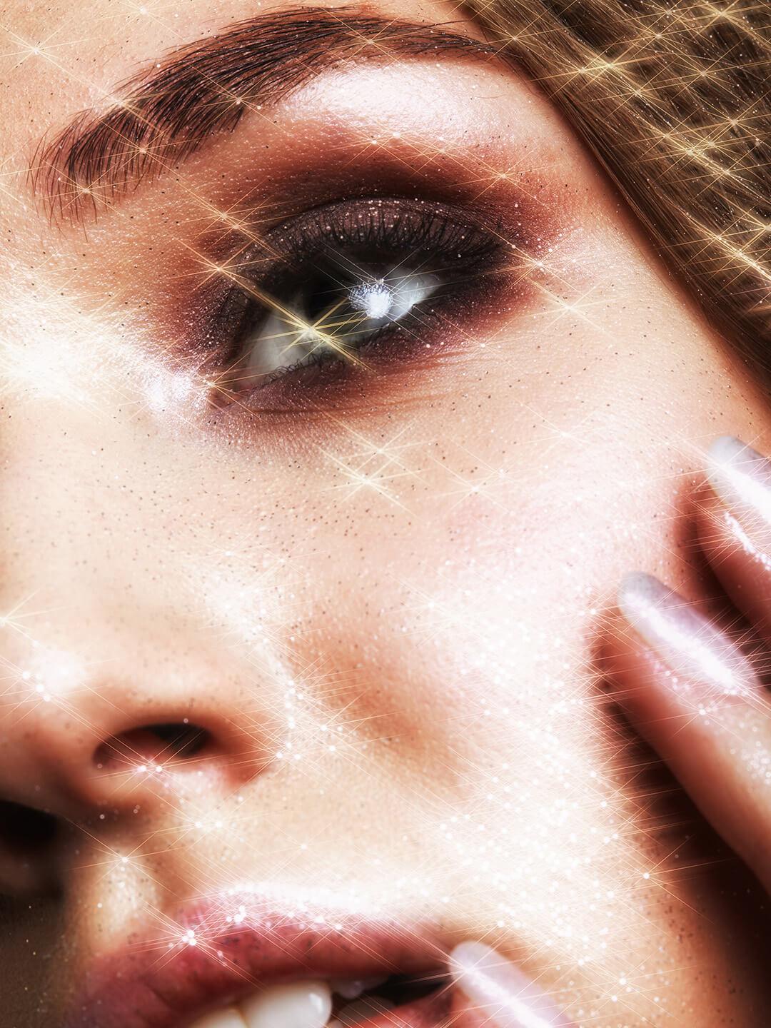 Close-up of beautiful young woman with vogue shining sparkle face makeup